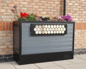 SuDS planter with BNG planted against a modern building to slow the flow. Rainwater planter.